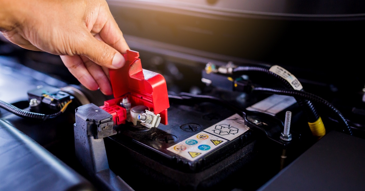 man checking car battery by himself