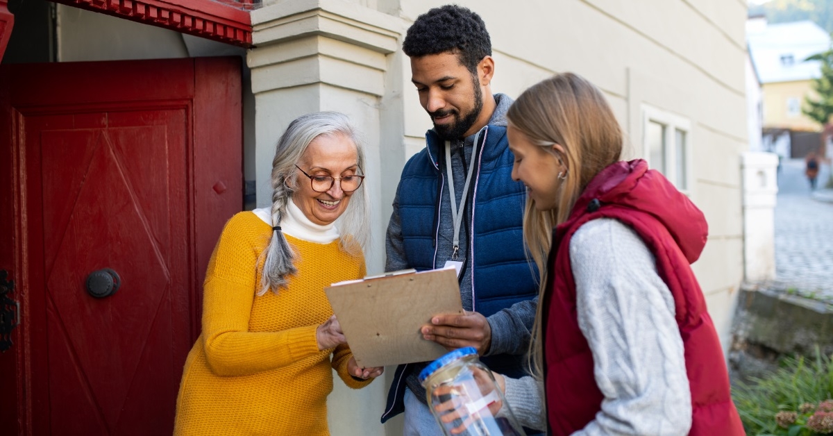 senior lady donating funds to volunteers