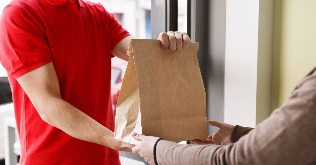 girl receiving package from delivery boy