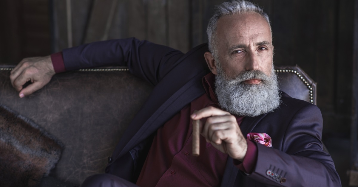 senior man posing with cigar