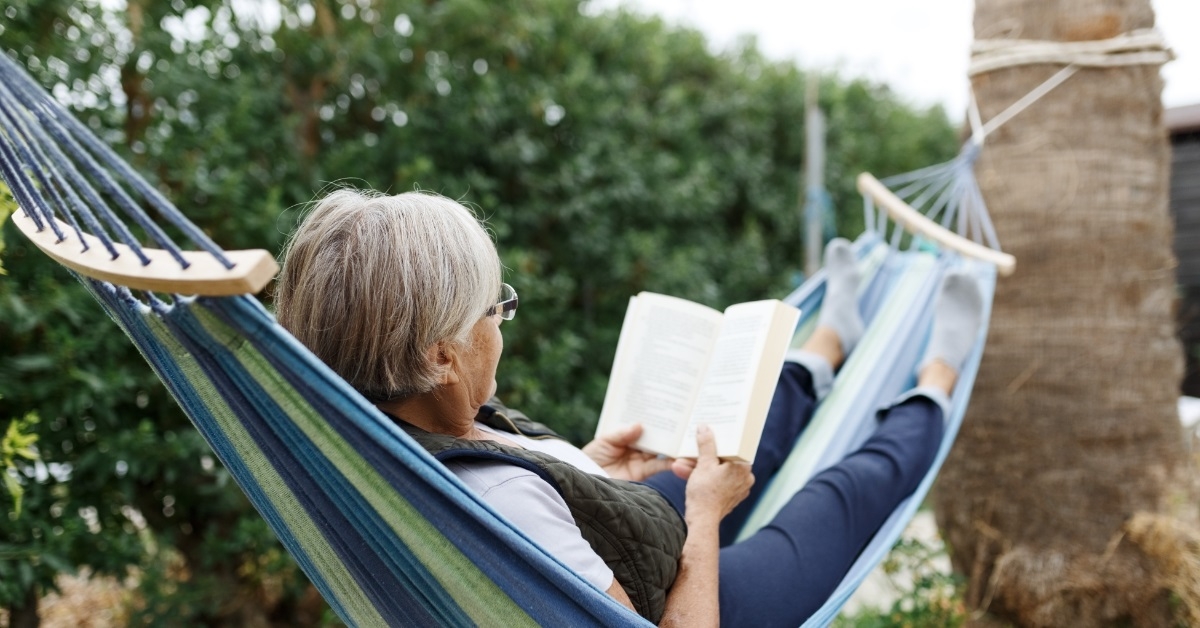 senior woman relaxing in hammock 