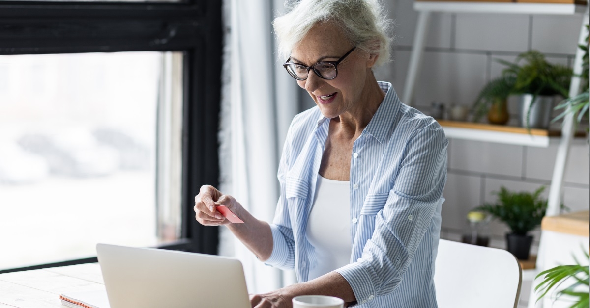 senior woman using card for shopping