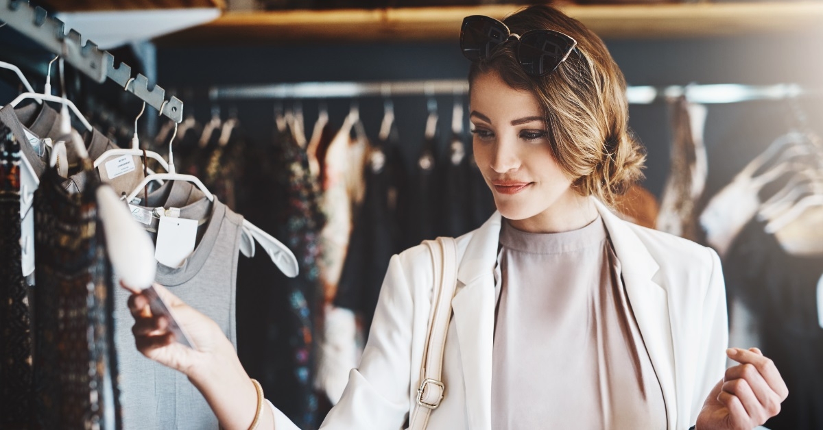woman checking price tag at boutique