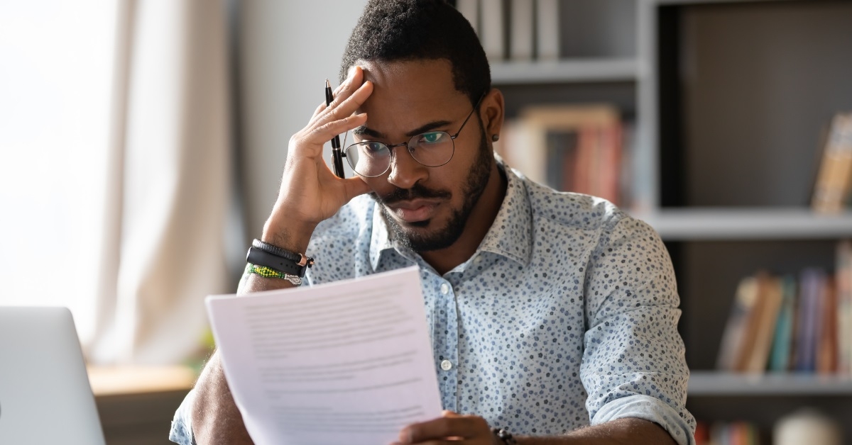 stressed african american man reviewing documents