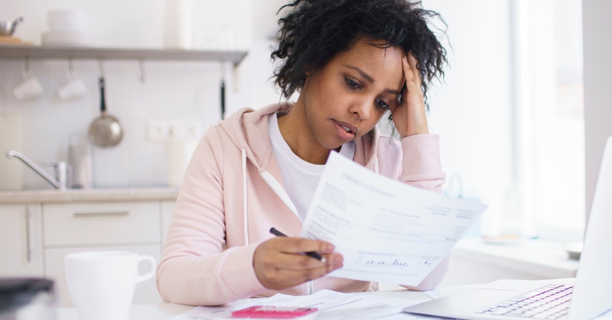 stressed african american woman reviewing bills
