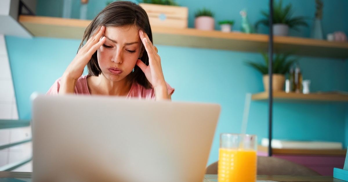 worried woman using laptop at home