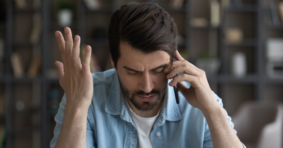 upset man talking on phone