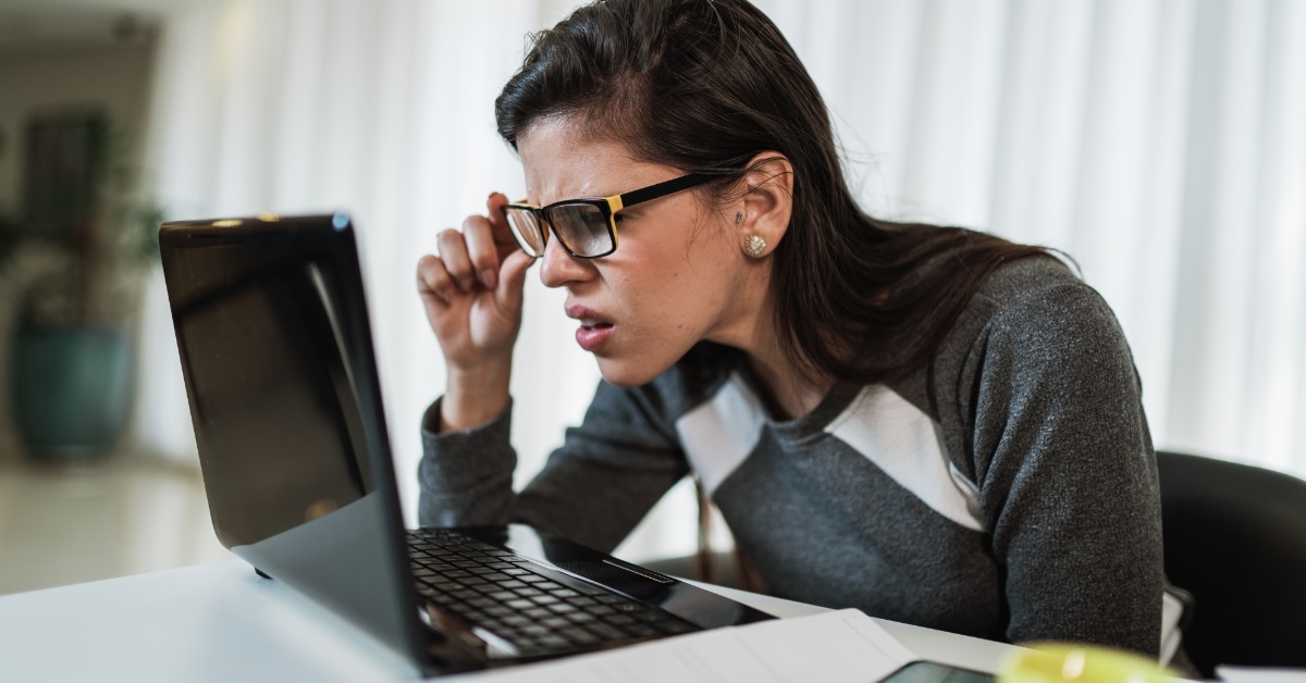 woman trying to read laptop screen