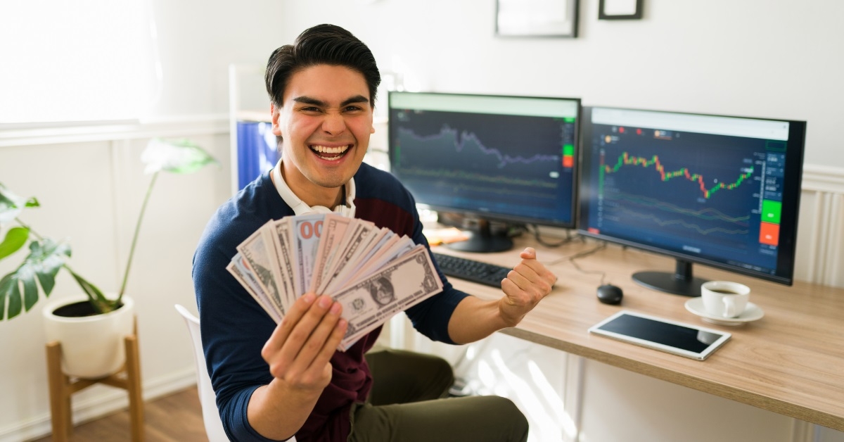 male broker holding money at work