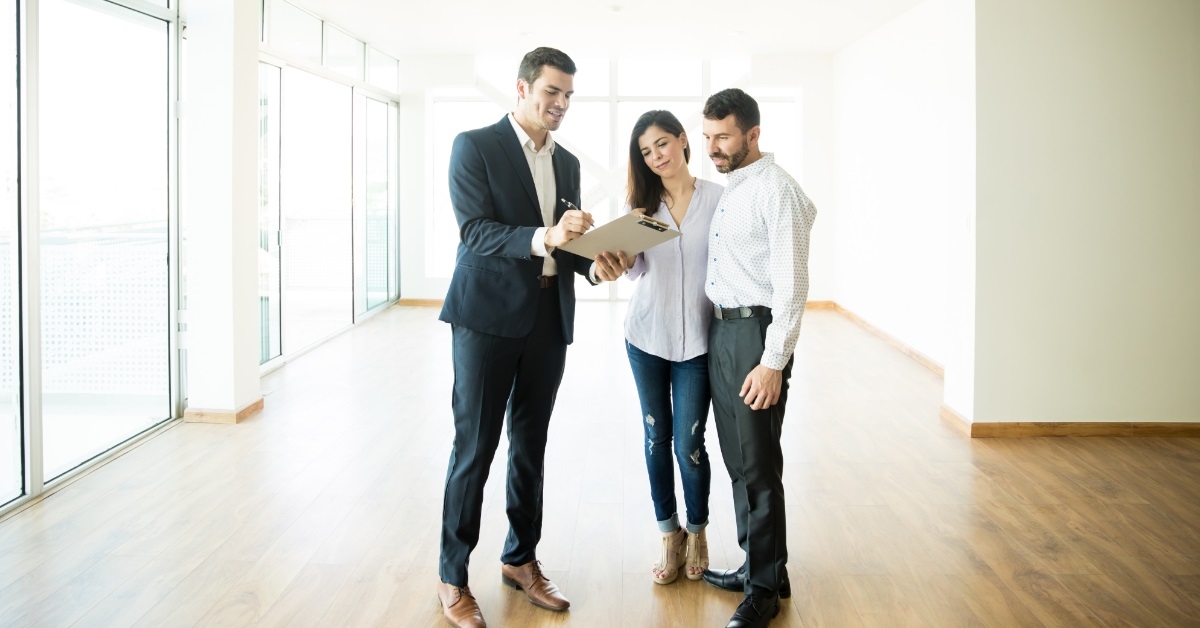 male realtor explaining contract to couple