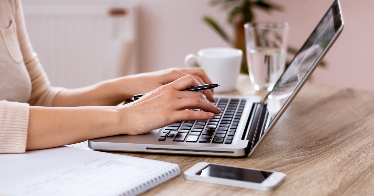 hands typing on laptop keyboard