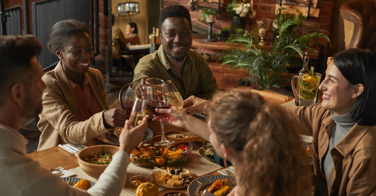 diverse group of people clinking glasses