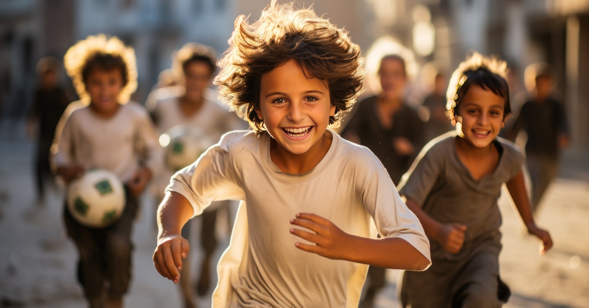 saudi children playing football in street