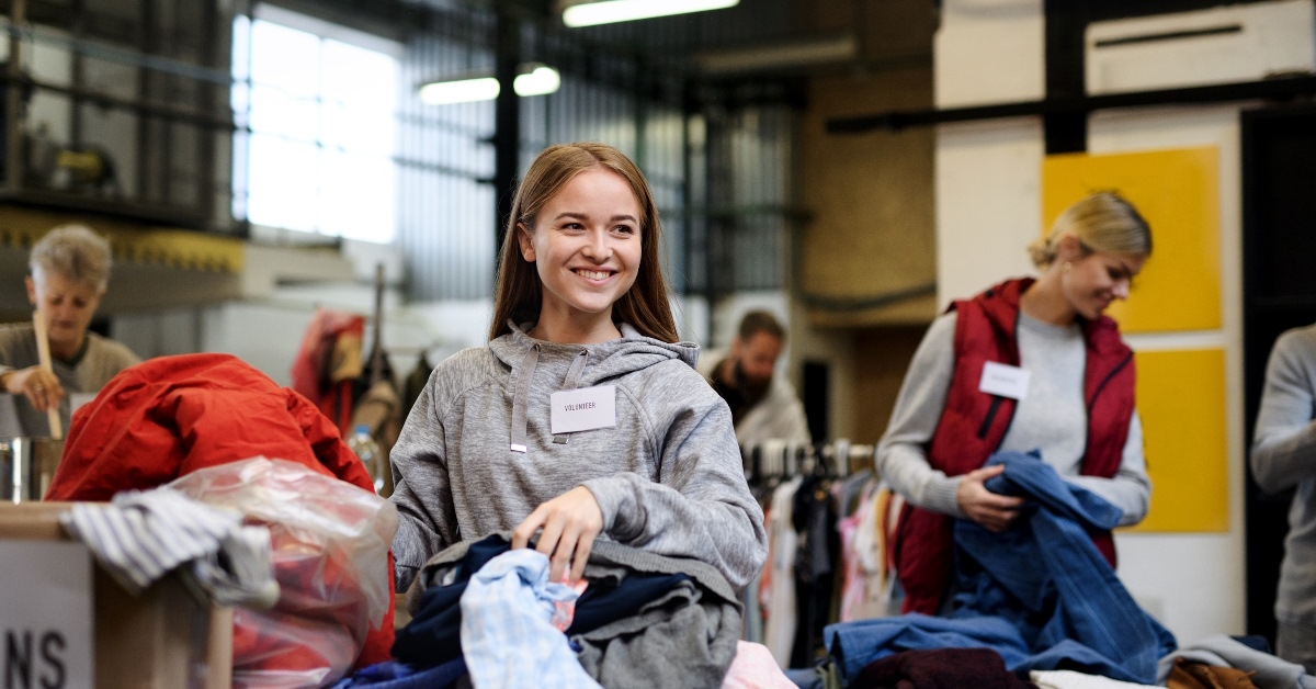 volunteers sorting clothes in donation center