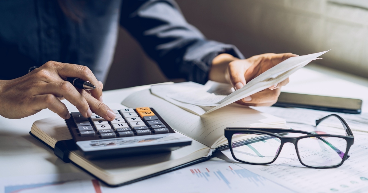 stressed young woman checking bills