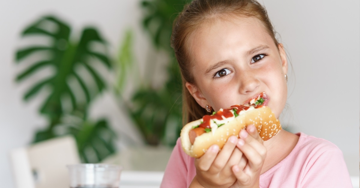 cute girl eating hot dog