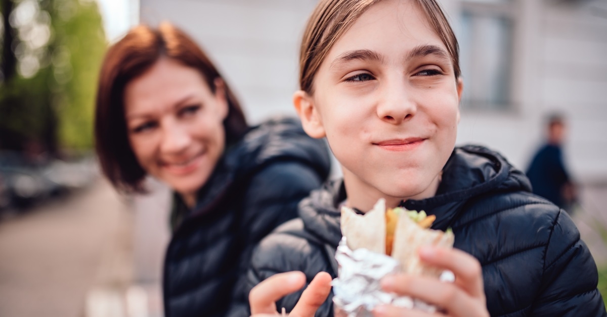 girls eating fast food on street
