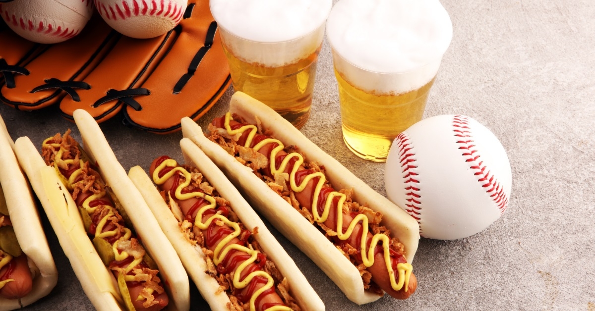 grilled hot dogs besides baseball accessories