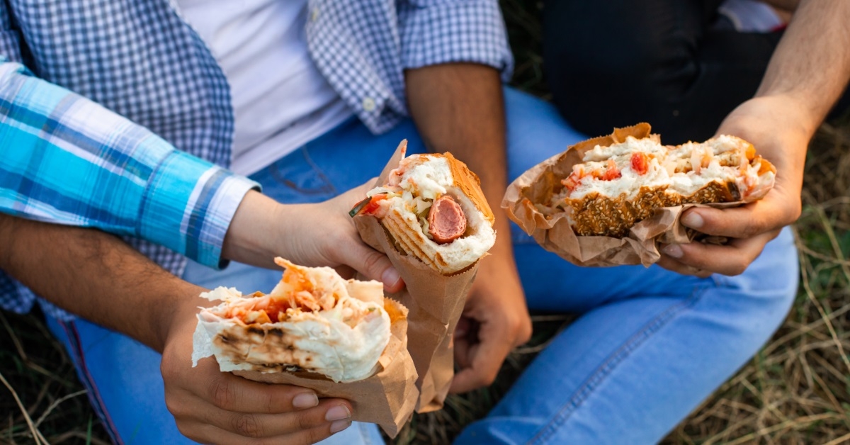 multi ethnic friends enjoying fast food