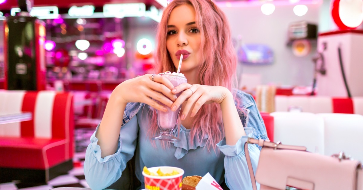 woman drinking shake at funky restaurant