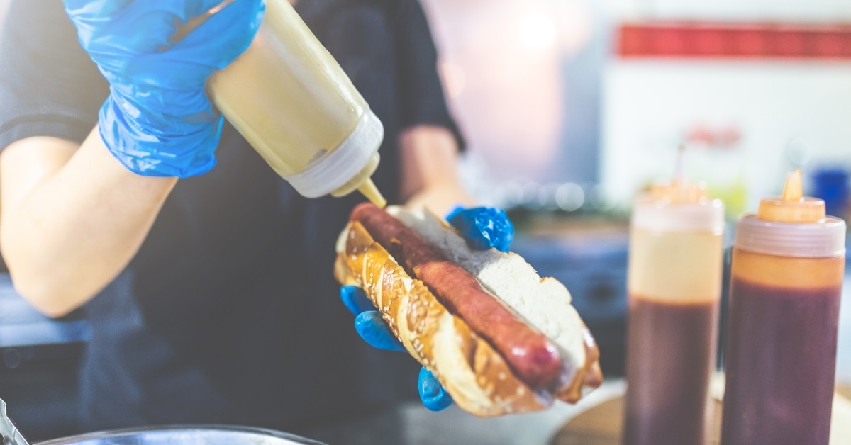 street food vendor preparing hot dog