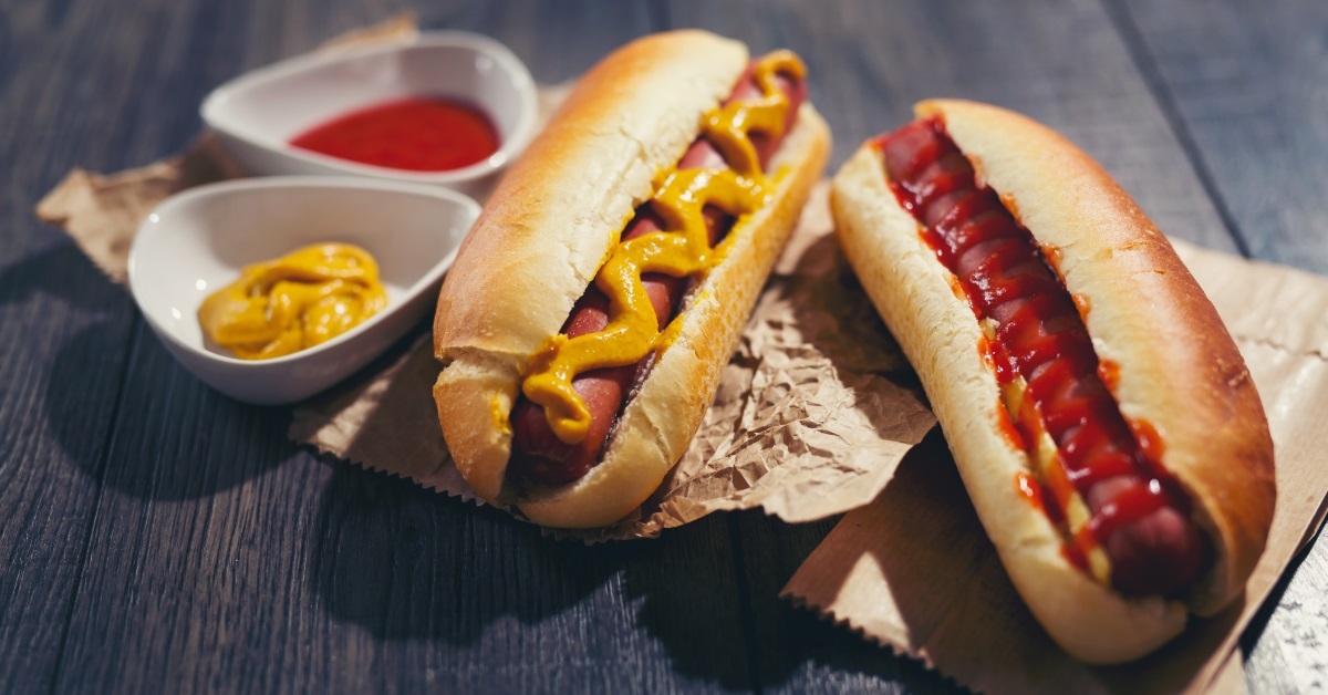 hot dogs with sauces on table