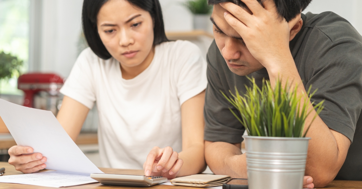 stressed couple calculating bills