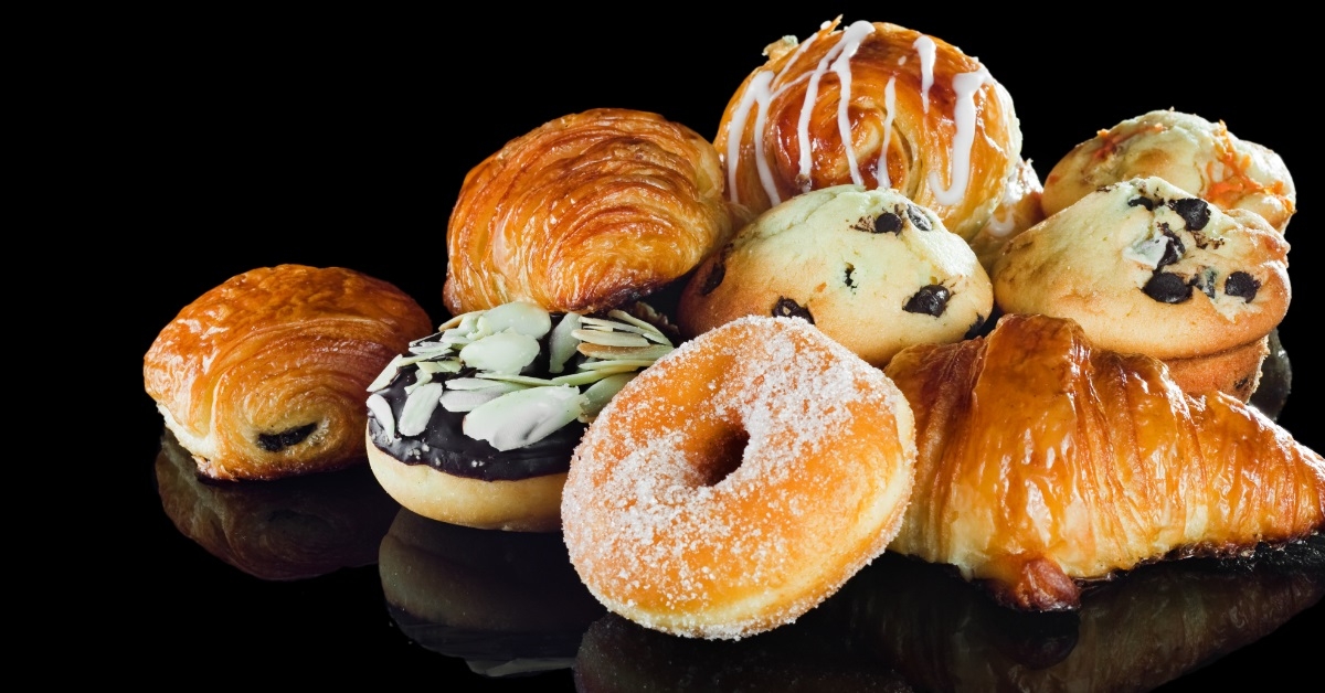 croissants doughnuts and muffins at table