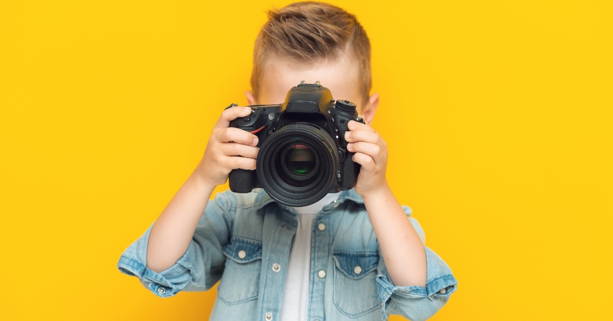kid taking photo with professional camera