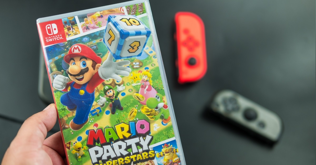 man holding nintendo switch mario game