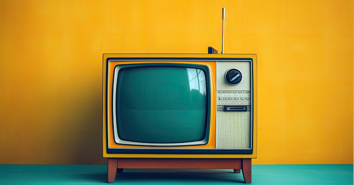 vintage analog television on orange backdrop