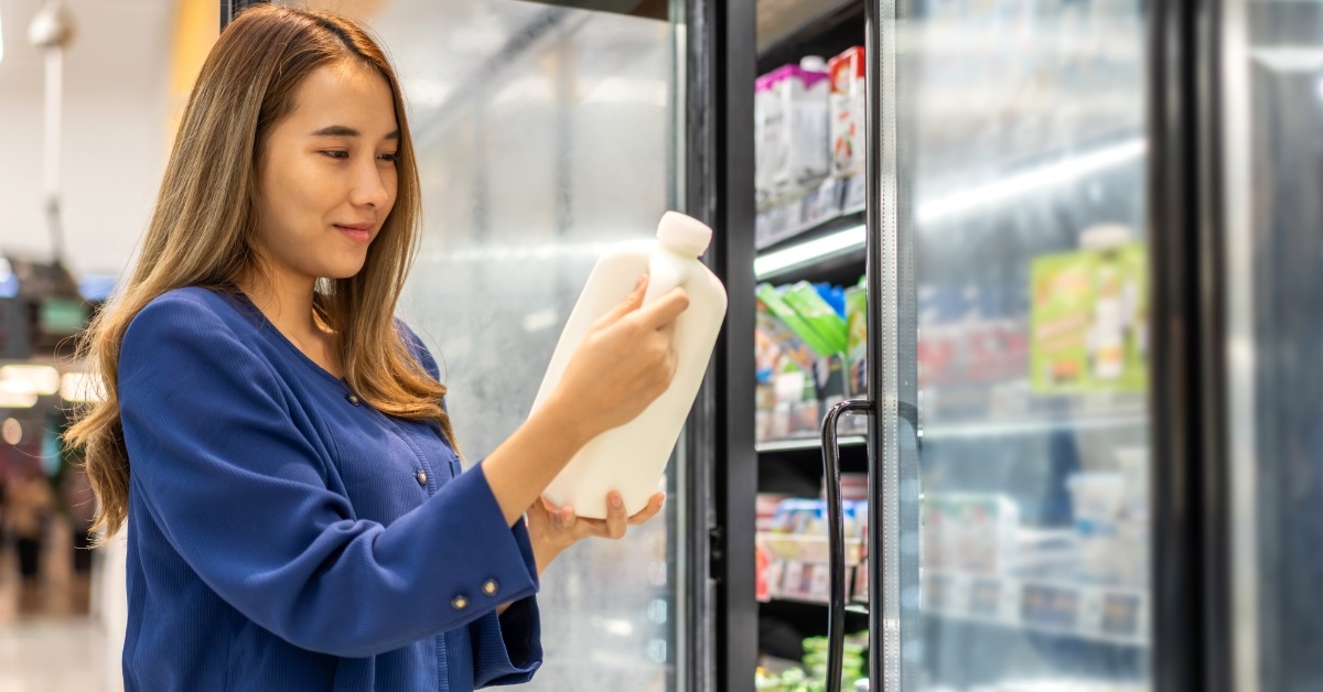 woman buying milk at dairy section