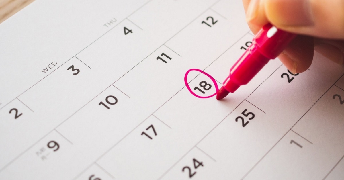 hand marking calendar using red sharpie