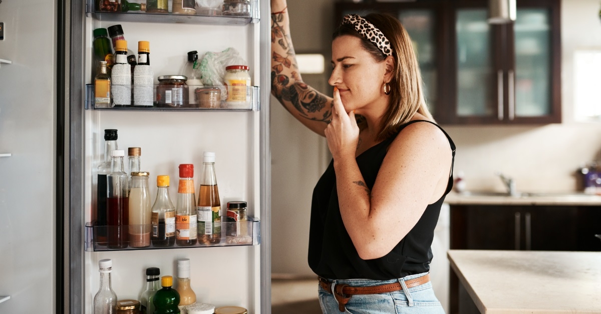 woman searching food in fridge