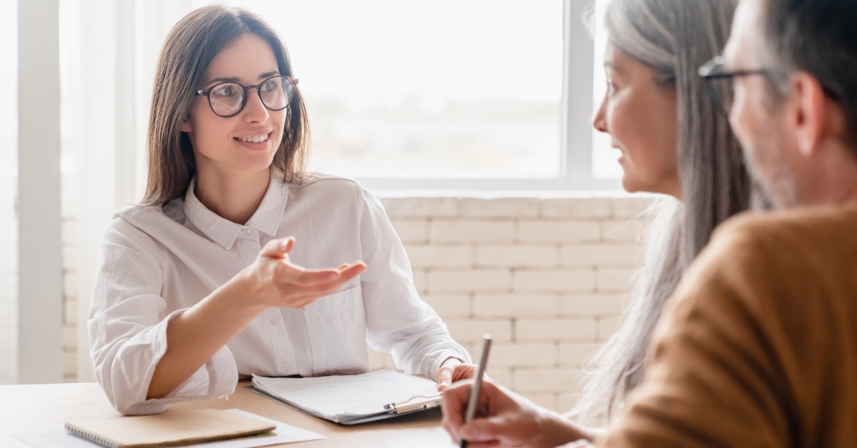 couple consulting female insurance agent