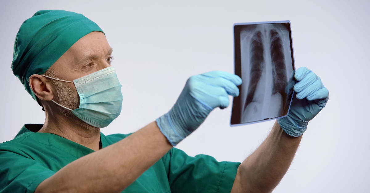 respiratory therapist looking at lungs scan