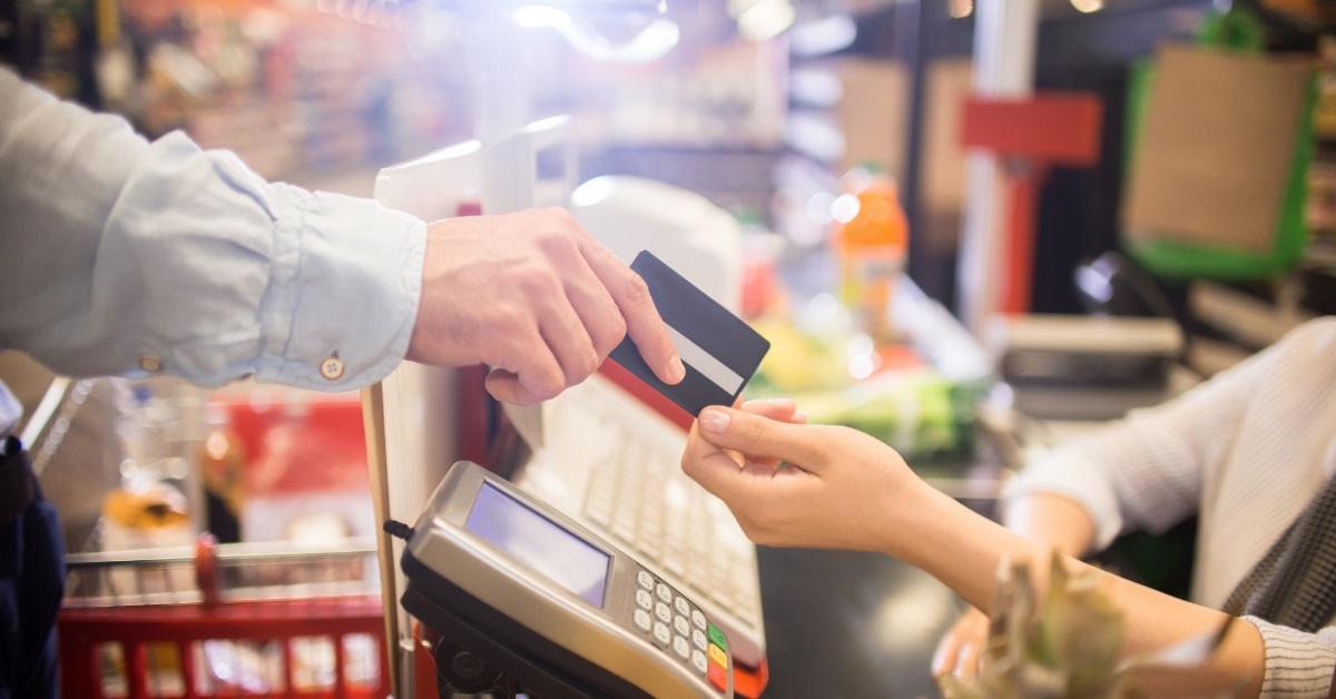 customer paying with card at cashier