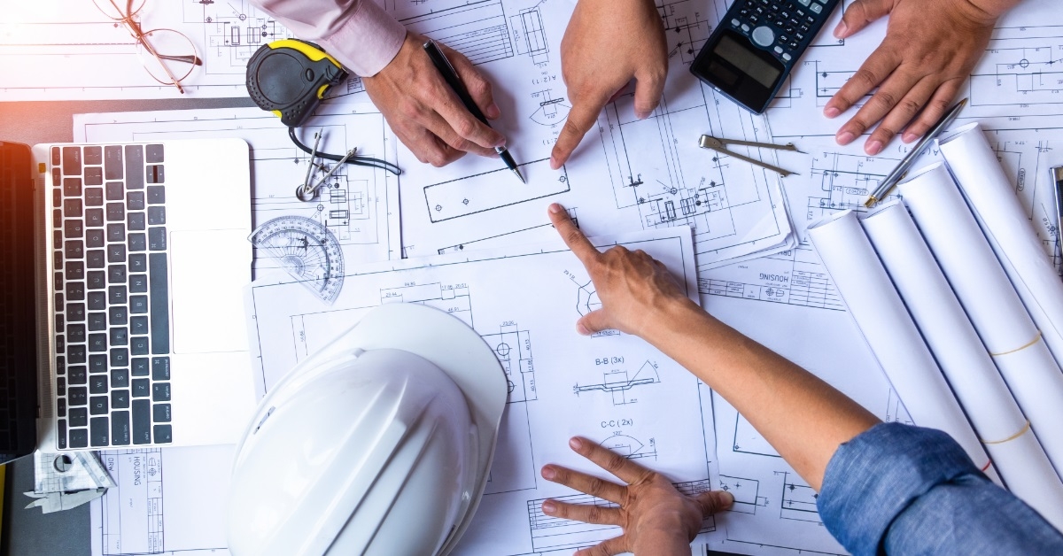 engineers building blueprints together