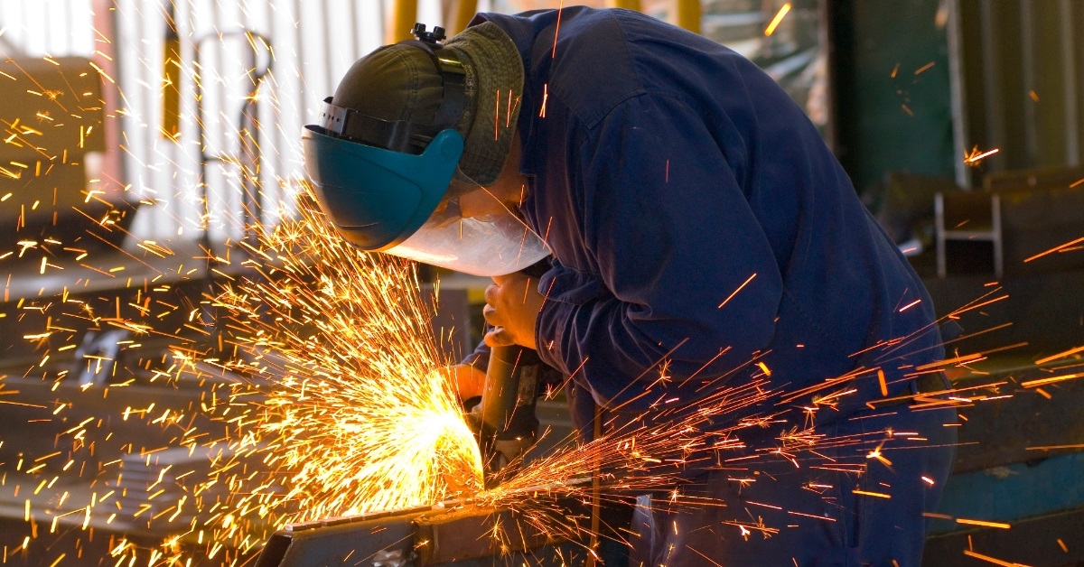 male worker grinding industrial steel