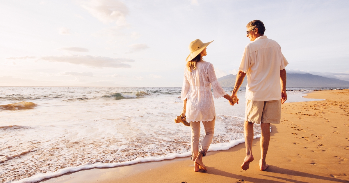 mature couple walking on the beach