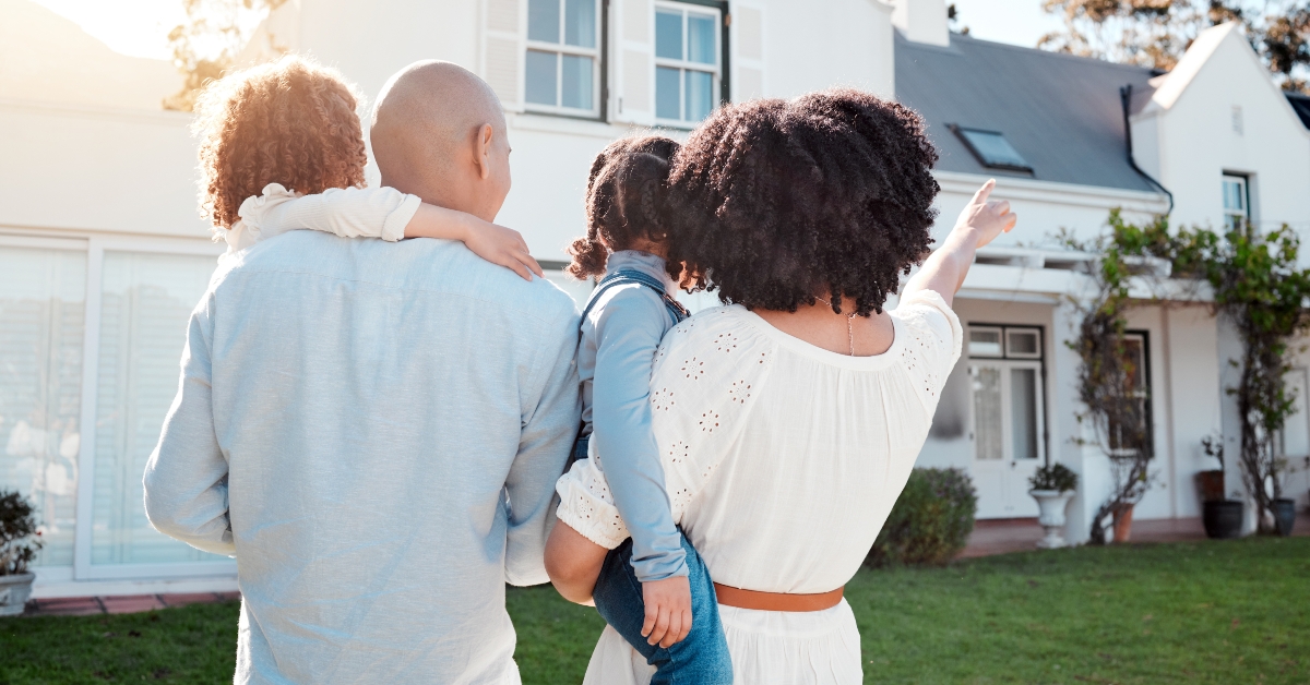 family in the yard of their new house