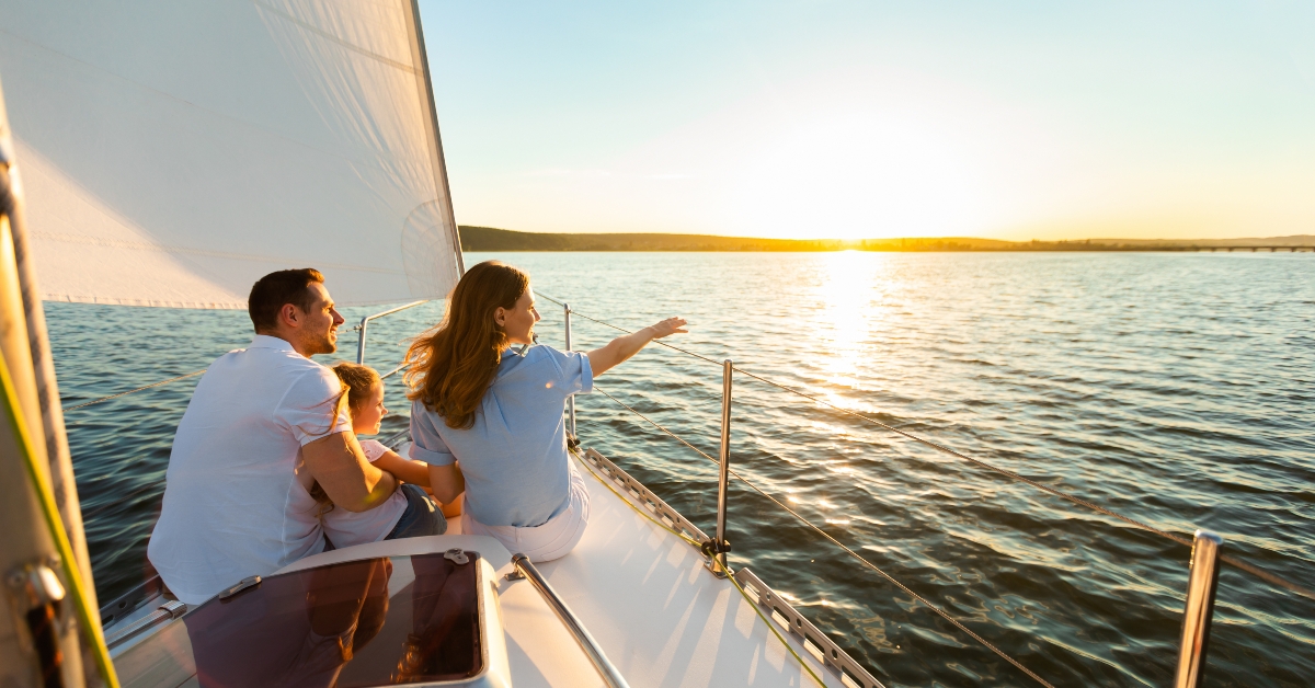 family of three sailing on yacht