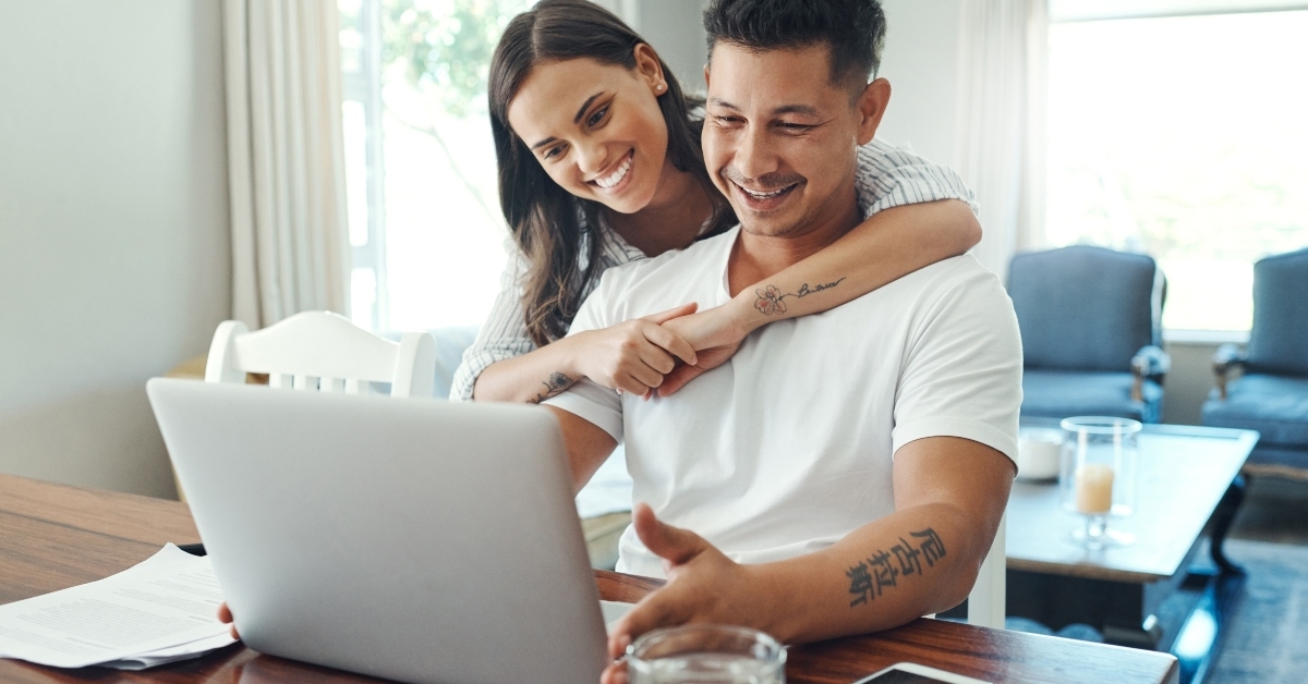 young couple using a laptop