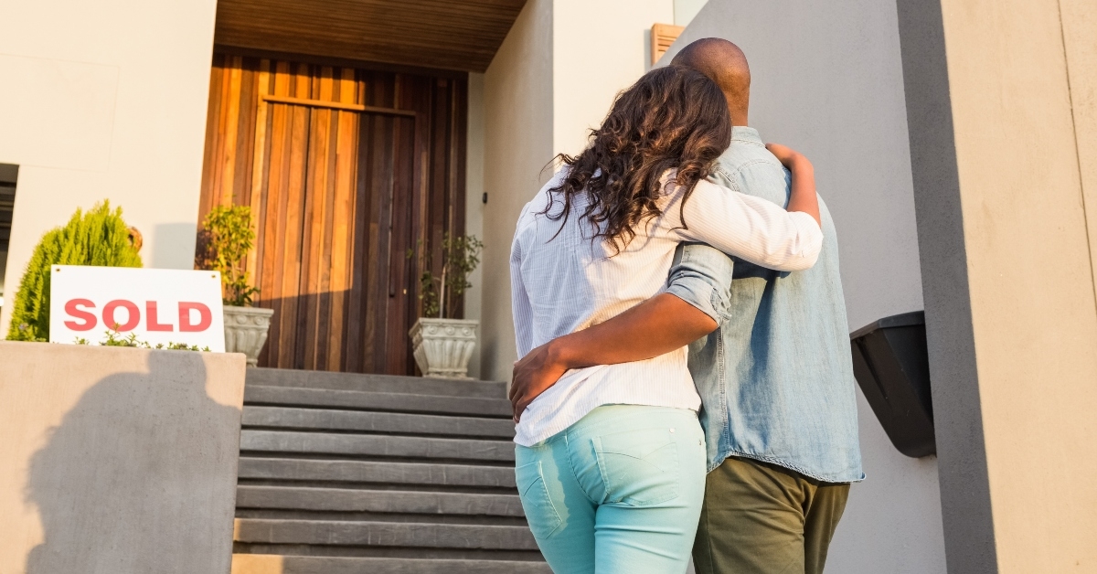 couple with arms above