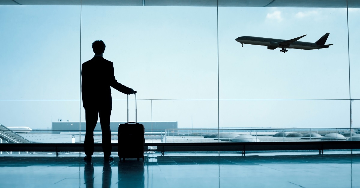 businessman in airport lounge with luggage