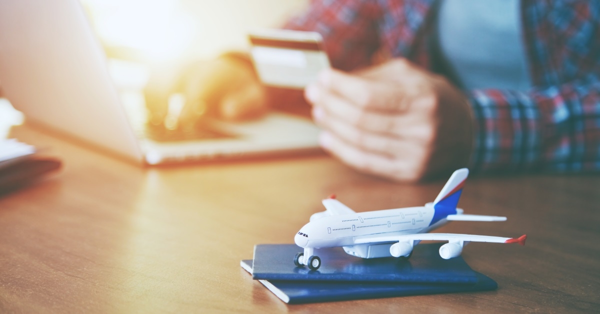 man booking airline tickets with passport