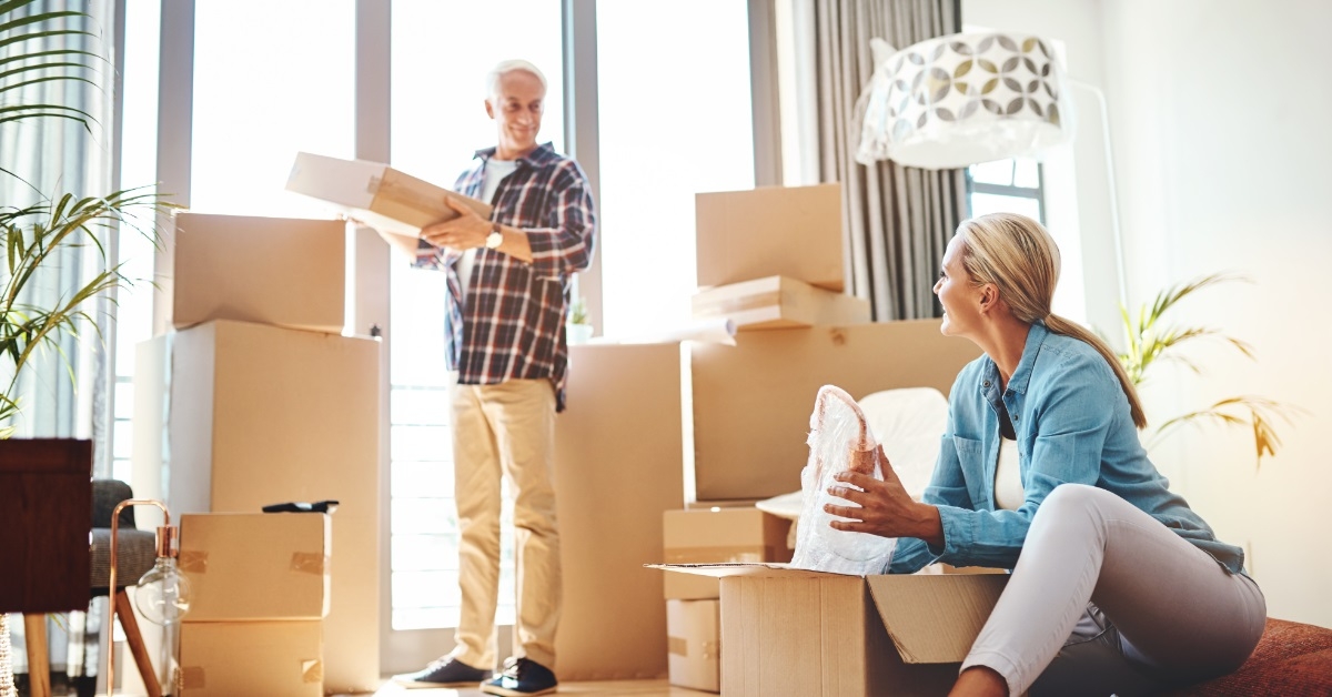 senior couple unpacking at new house