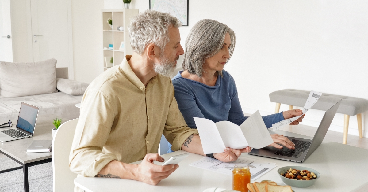 middle aged couple paying bills