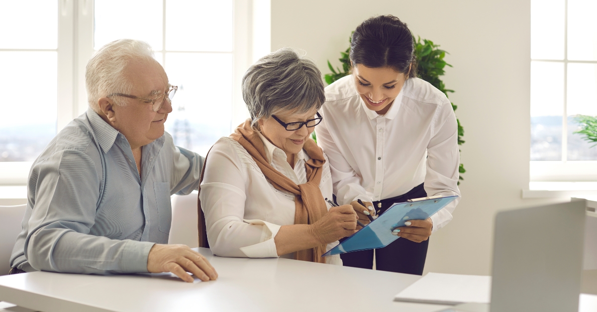 senior couple sign a legal paper