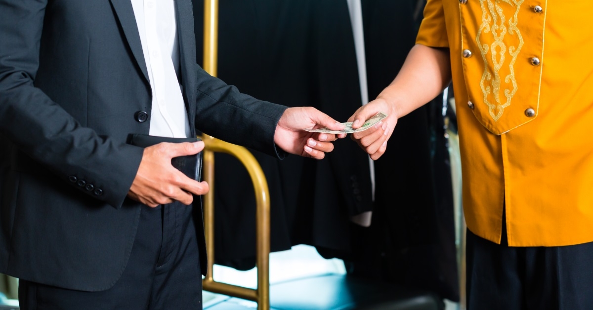 hotel server receiving tip from businessman